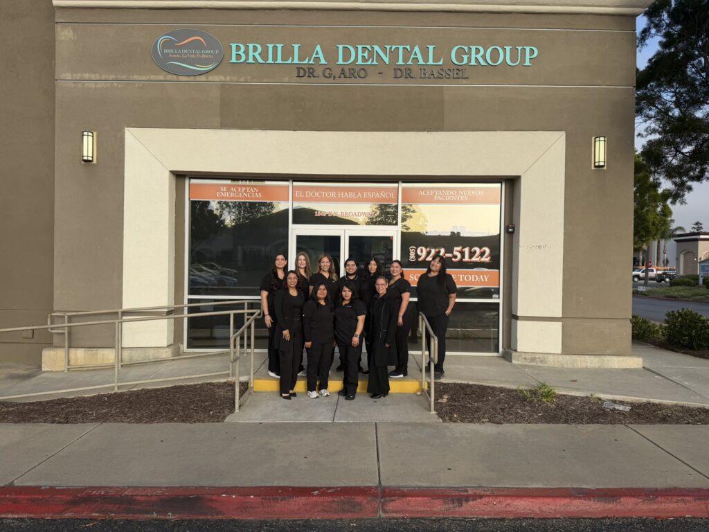 Dental team and office staff of Brilla Dental Group standing outside their practice building in Santa Maria.